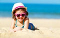 Happy child girl in bikini on beach in summer sea Royalty Free Stock Photo