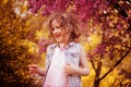 Happy child girl at blooming cherry tree in spring garden Royalty Free Stock Photo