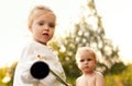 Happy child girl and boy kid playing game in backyard at summer. Happy childhood in summer days together in park. American blonde Royalty Free Stock Photo