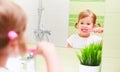 Happy child girl brushing her teeth toothbrushes in bathroom Royalty Free Stock Photo