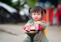 Happy child girl with a car toy, cute kid playing outdoors