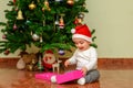 Happy child girl with a Christmas gift. Royalty Free Stock Photo