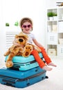 Happy child girl collect suitcase on vacation Royalty Free Stock Photo