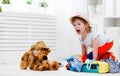 Happy child girl collect suitcase on vacation Royalty Free Stock Photo