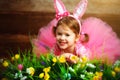 Happy child girl in costume Easter bunny rabbit on grass and fl Royalty Free Stock Photo