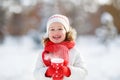 Happy child girl with a cup of hot tea in winter walk Royalty Free Stock Photo