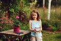 happy child girl decorating evening summer garden with candle holder Royalty Free Stock Photo