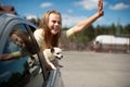 Happy child girl and dog chihuahua looking out the open car window Royalty Free Stock Photo