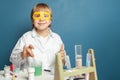 Happy child girl doing science experiments. Science and education concept