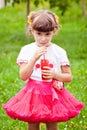 Happy child girl drinks juice Royalty Free Stock Photo