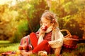 Happy child girl eating apples in autumn sunny garden Royalty Free Stock Photo