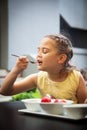 happy child girl eats strawberries in the summer,Young cute smiling european little girl is eating ripe jucy strawberry with sour Royalty Free Stock Photo