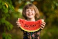 Happy child girl eats watermelon in summer Royalty Free Stock Photo