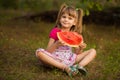 Happy child girl eats watermelon in summer Royalty Free Stock Photo