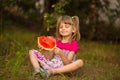 Happy child girl eats watermelon in summer Royalty Free Stock Photo