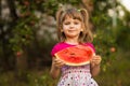 Happy child girl eats watermelon in summer. Healthy concept