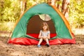 Happy child girl enjoy summer time in camping tent in summer forest Royalty Free Stock Photo