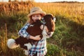 Happy child girl enjoying summer vacations with her dog, walking and playing on sunny meadow Royalty Free Stock Photo