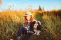 Happy child girl enjoying summer vacations with her dog, walking and playing on sunny meadow Royalty Free Stock Photo