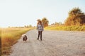 Happy child girl enjoying summer vacations with her dog, walking and playing on sunny meadow Royalty Free Stock Photo