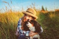 Happy child girl enjoying summer vacations with her dog, walking and playing on sunny meadow Royalty Free Stock Photo