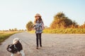 Happy child girl enjoying summer vacations with her dog, walking and playing on sunny meadow Royalty Free Stock Photo