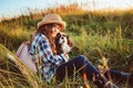 Happy child girl enjoying summer vacations with her dog, walking and playing on sunny meadow Royalty Free Stock Photo