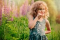 Happy child girl exploring nature with loupe on summer walk Royalty Free Stock Photo