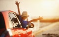 Happy child girl goes to summer travel trip in car Royalty Free Stock Photo
