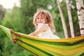 Happy child girl having fun and relaxing in hammock in summer Royalty Free Stock Photo