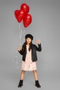 happy child girl holding red heart shaped balloon Royalty Free Stock Photo