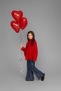 happy child girl holding red heart shaped balloon Royalty Free Stock Photo