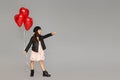 Happy child girl holding red heart shaped balloon Royalty Free Stock Photo