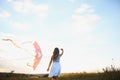 happy child girl with a kite running on meadow in summer in nature Royalty Free Stock Photo