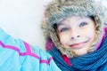 Happy child girl laying down on a frozen clear snow Royalty Free Stock Photo