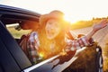 happy child girl looking out the car window during road trip on summer vacations. Royalty Free Stock Photo
