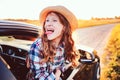 Happy child girl looking out the car window during road trip on summer vacations. Royalty Free Stock Photo