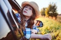 Happy child girl looking out the car window during road trip on summer vacations. Royalty Free Stock Photo