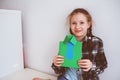 Happy child girl making greeting card for Fathers Day