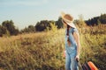 Happy child girl with orange suitcase traveling alone on summer vacation. Kid going to summer camp. Royalty Free Stock Photo