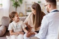 Happy child girl patient with his mother at reception of a friendly pediatrician family doctor pediatrician Royalty Free Stock Photo