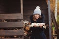 Happy child girl picking firewood from shed in winter Royalty Free Stock Photo