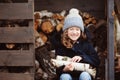 Happy child girl picking firewood from shed in winter Royalty Free Stock Photo