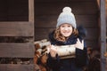 Happy child girl picking firewood from shed in winter Royalty Free Stock Photo