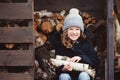 Happy child girl picking firewood from shed in winter Royalty Free Stock Photo