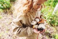 Happy child girl picking wild mushrooms on the walk in summer Royalty Free Stock Photo