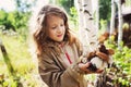 Happy child girl picking wild mushrooms on the walk in summer Royalty Free Stock Photo