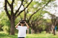 Happy child girl playing with binoculars. explore and adventure concept Royalty Free Stock Photo