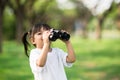 Happy child girl playing with binoculars. explore and adventure concept Royalty Free Stock Photo