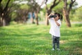Happy child girl playing with binoculars. explore and adventure concept Royalty Free Stock Photo